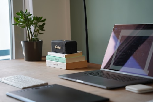 a laptop computer sitting on top of a wooden desk