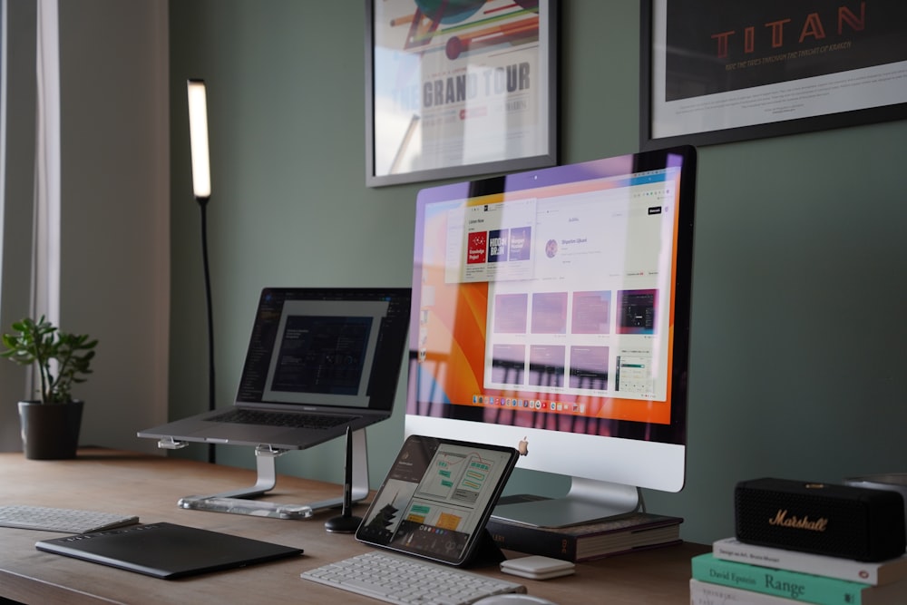 a desk with a laptop and a monitor on it