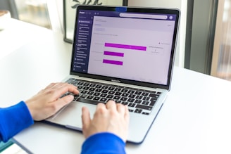 a person using a laptop computer on a desk