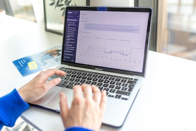 a person using a laptop computer on a desk