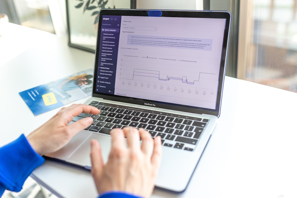 a person using a laptop computer on a desk