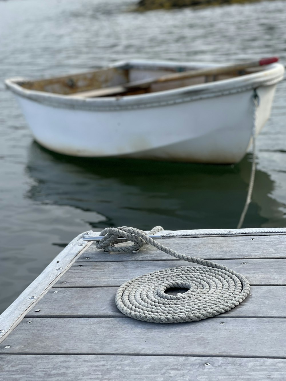 a boat tied to a dock with a rope