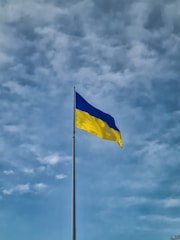 a blue and yellow flag flying in the wind