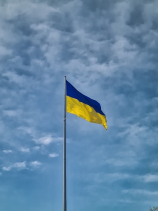 a blue and yellow flag flying in the wind