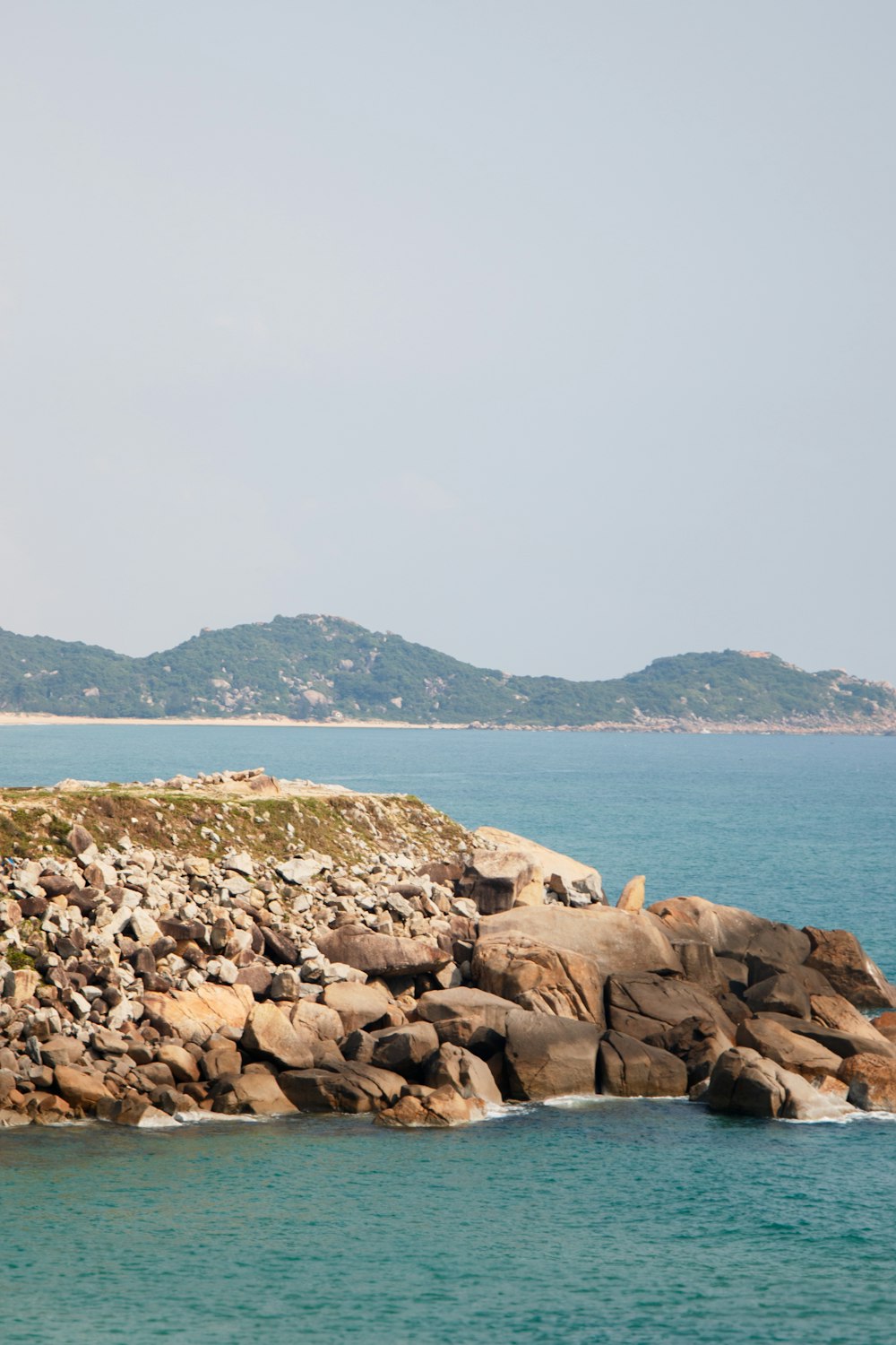 a large body of water next to a rocky shore