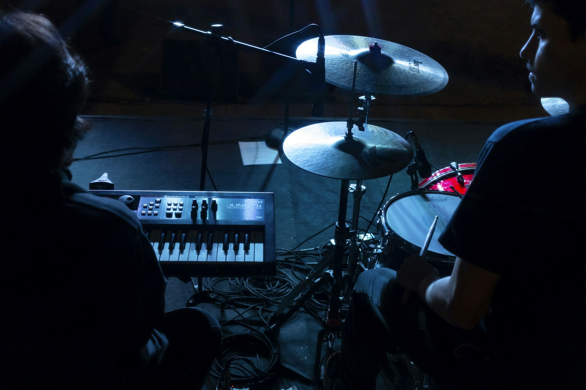 a man sitting in front of a drum set