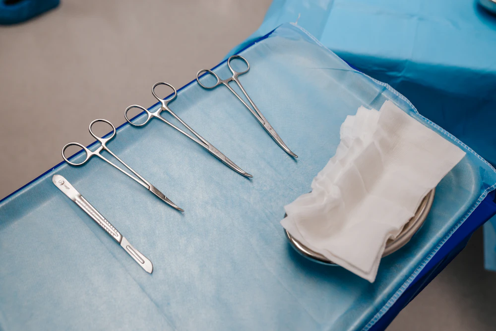 A tray of stainless steel surgical instruments