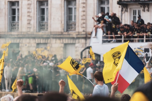 a group of people holding flags in front of a building