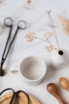 a close up of a table with scissors and a vase