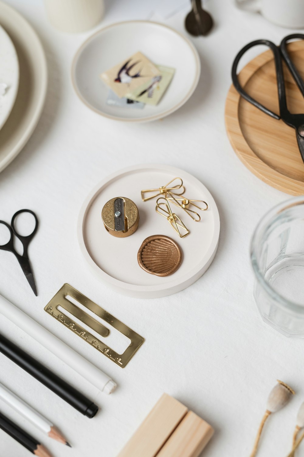 a white table topped with lots of craft supplies