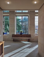 A bright room with large glass windows letting in light.