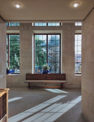 A serene therapy room with natural light, plants, and art supplies.