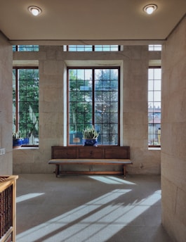 A serene, sunlit room with cozy cushions and plants, inviting for a healing workshop.