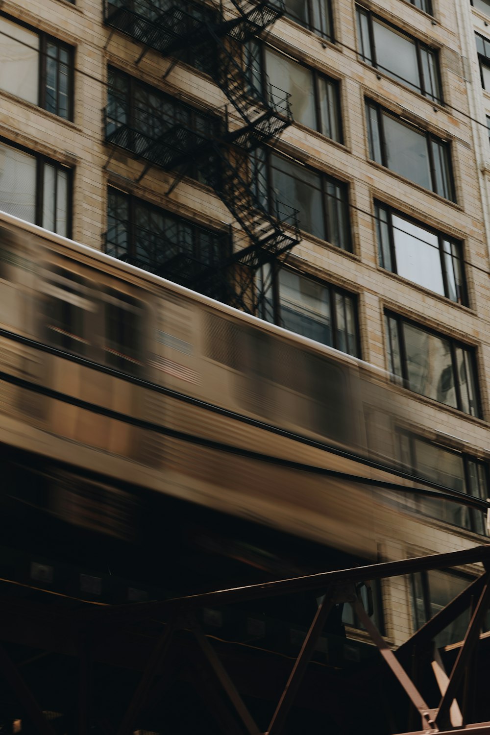 a train is passing by a tall building