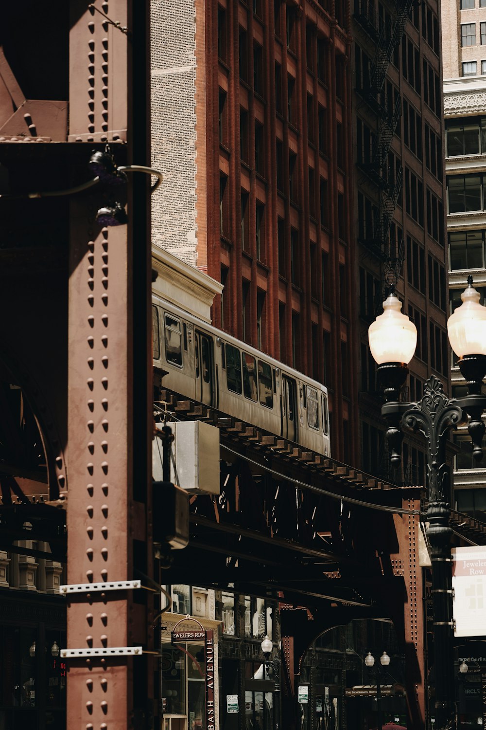 a train traveling through a city next to tall buildings