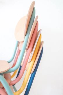 Colorful wooden kids' chairs arranged in a playful setting.