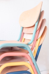 a stack of colorful chairs sitting next to each other