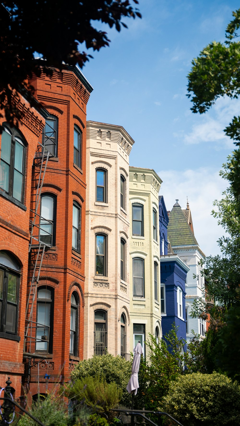 a row of multi - colored houses in a neighborhood