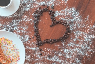 a heart made out of coffee beans and sprinkles