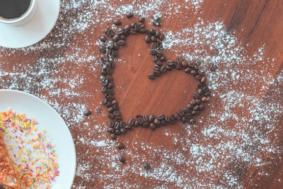 a heart made out of coffee beans and sprinkles