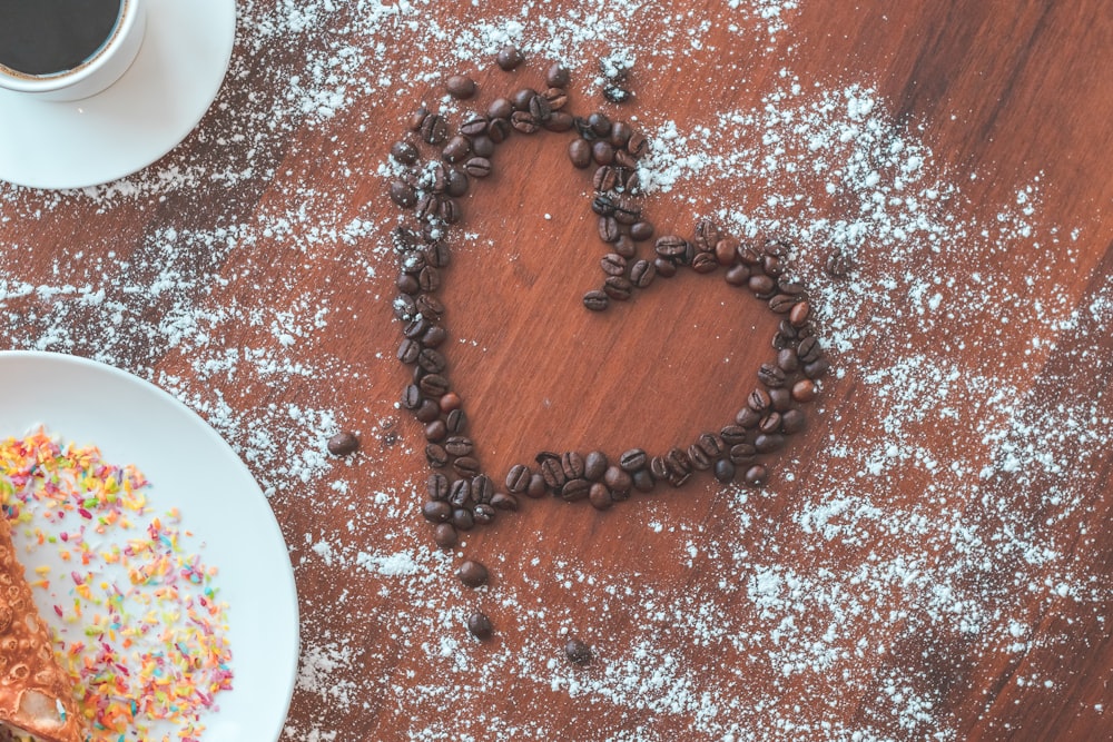 a heart made out of coffee beans and sprinkles