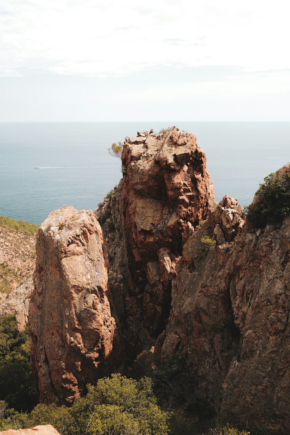 a large rock formation with a body of water in the background