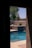 Peaceful backyard with a pristine swimming pool and well-kept garden greenery.