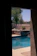A serene backyard featuring a beautifully installed fiberglass pool surrounded by lush greenery.
