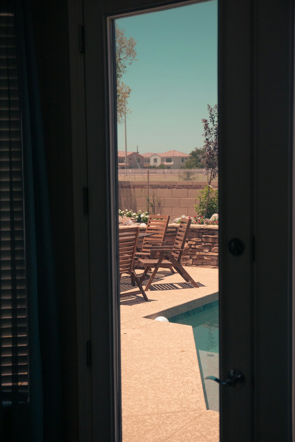 a view of a pool through an open door