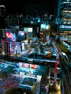 A vibrant cityscape featuring digital billboards and LED displays.