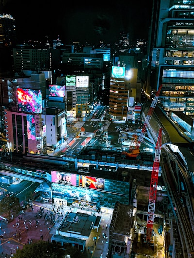 A vibrant cityscape featuring digital billboards and LED displays.