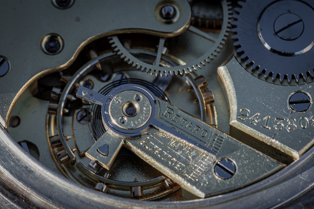 a close up of a watch face with gears