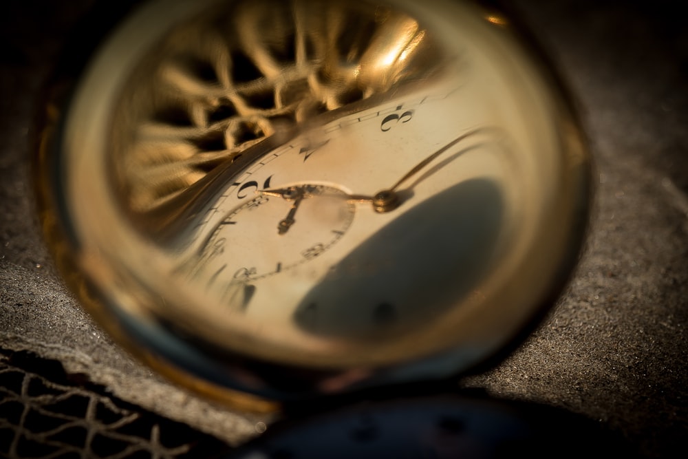 a close up of a gold pocket watch