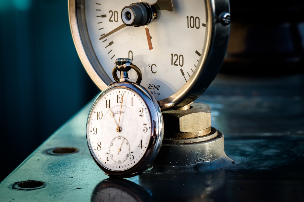 a close up of a clock on a table