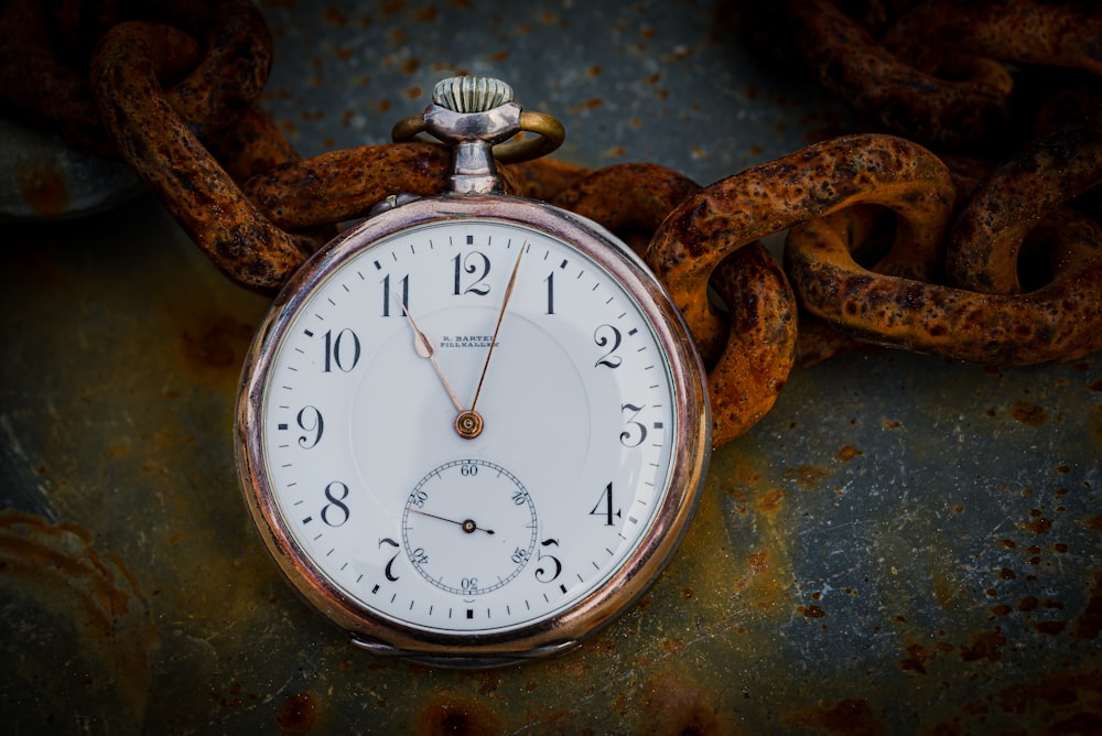 a close up of a pocket watch on a chain