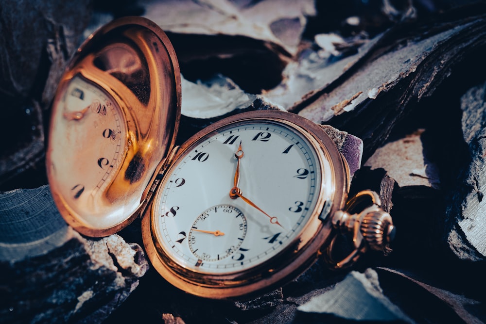 a close up of a pocket watch laying on the ground