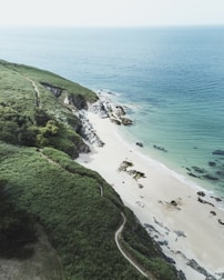 A serene landscape of the Algarve coastline with people exploring.