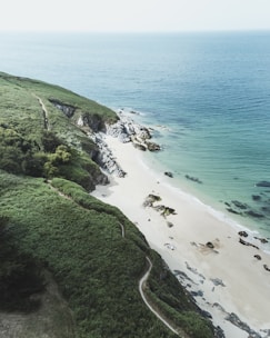 A serene landscape of the Algarve coastline with people exploring.