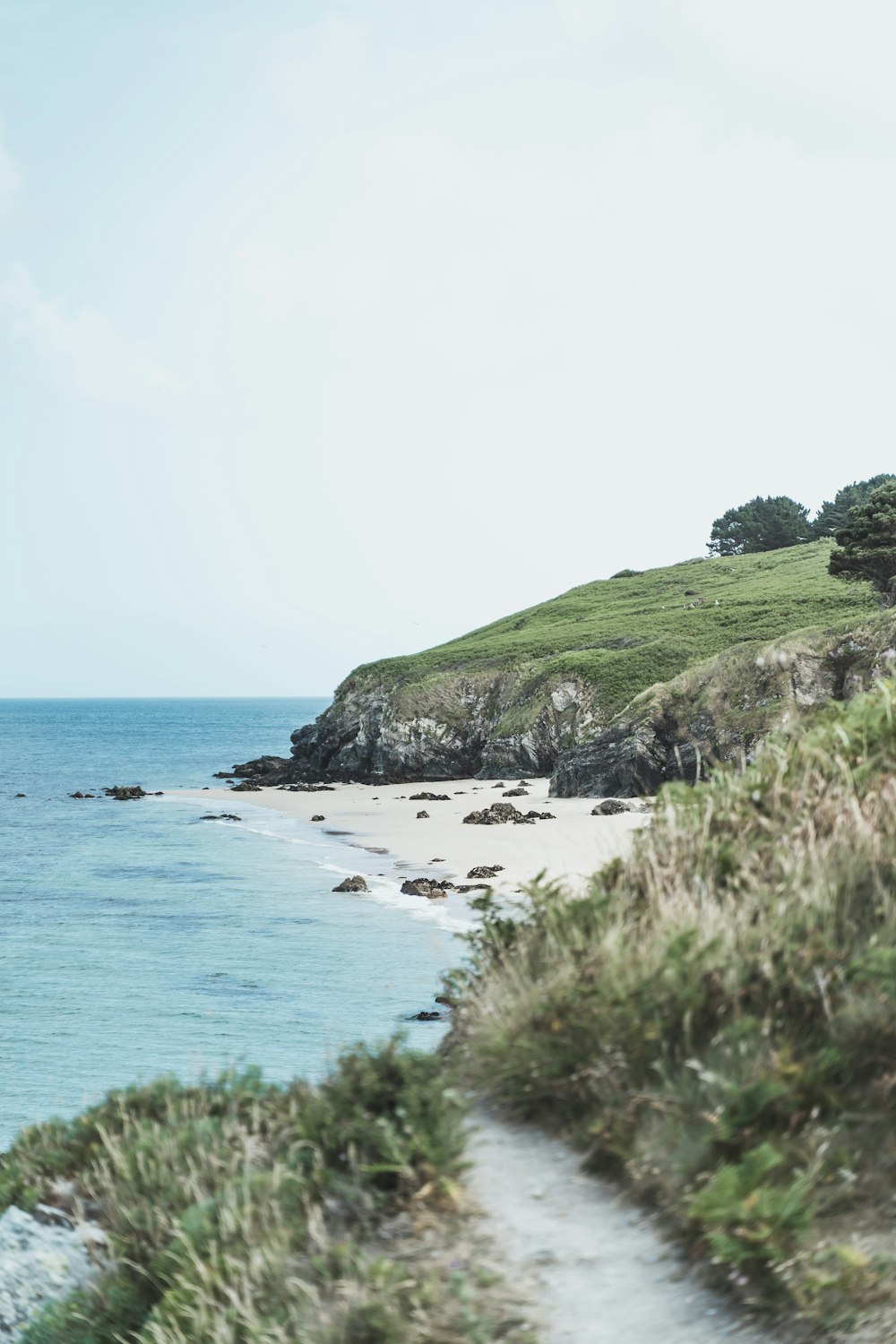 a path leading to a beach next to the ocean