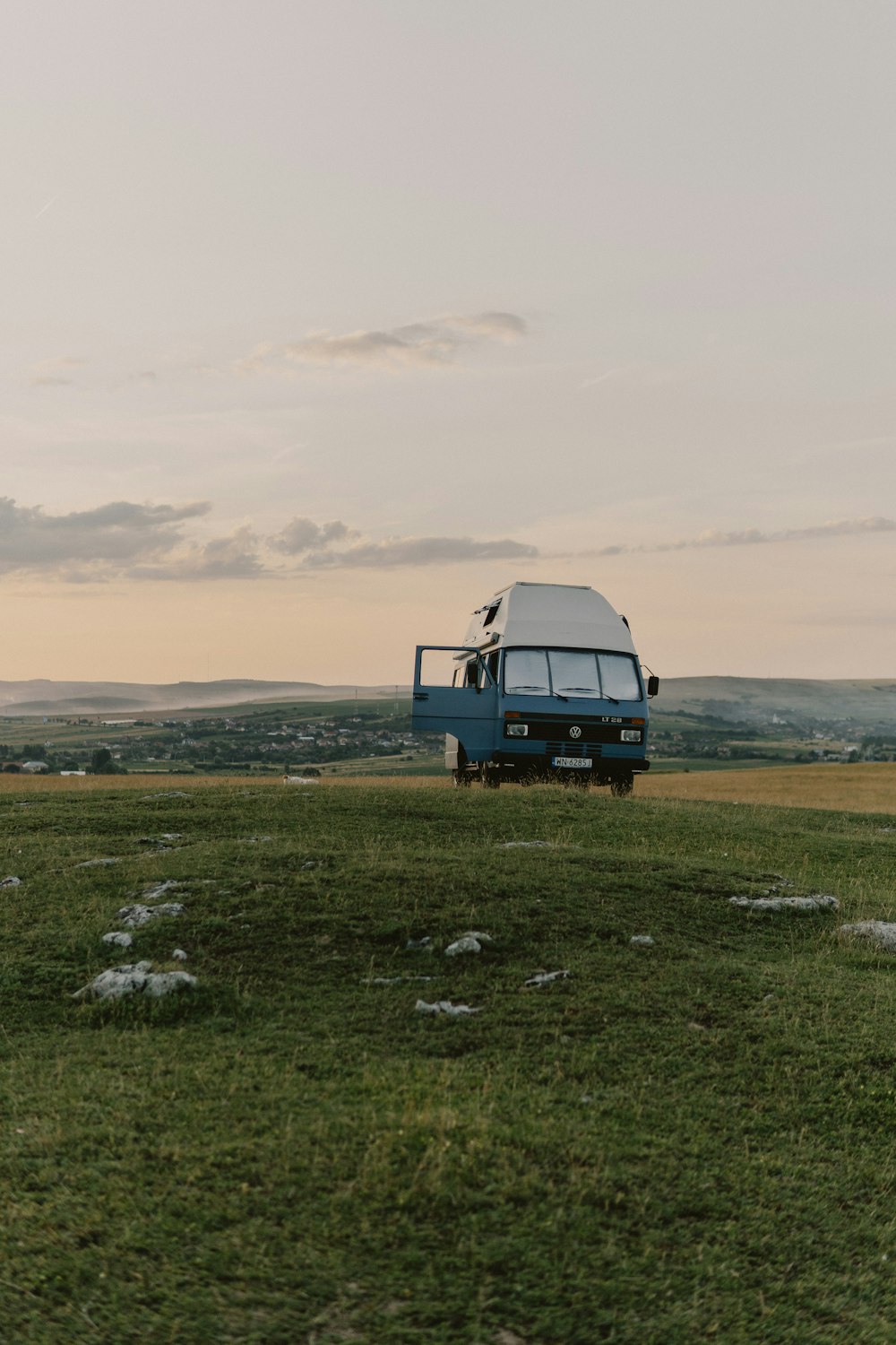 a truck parked in a field with a sky background