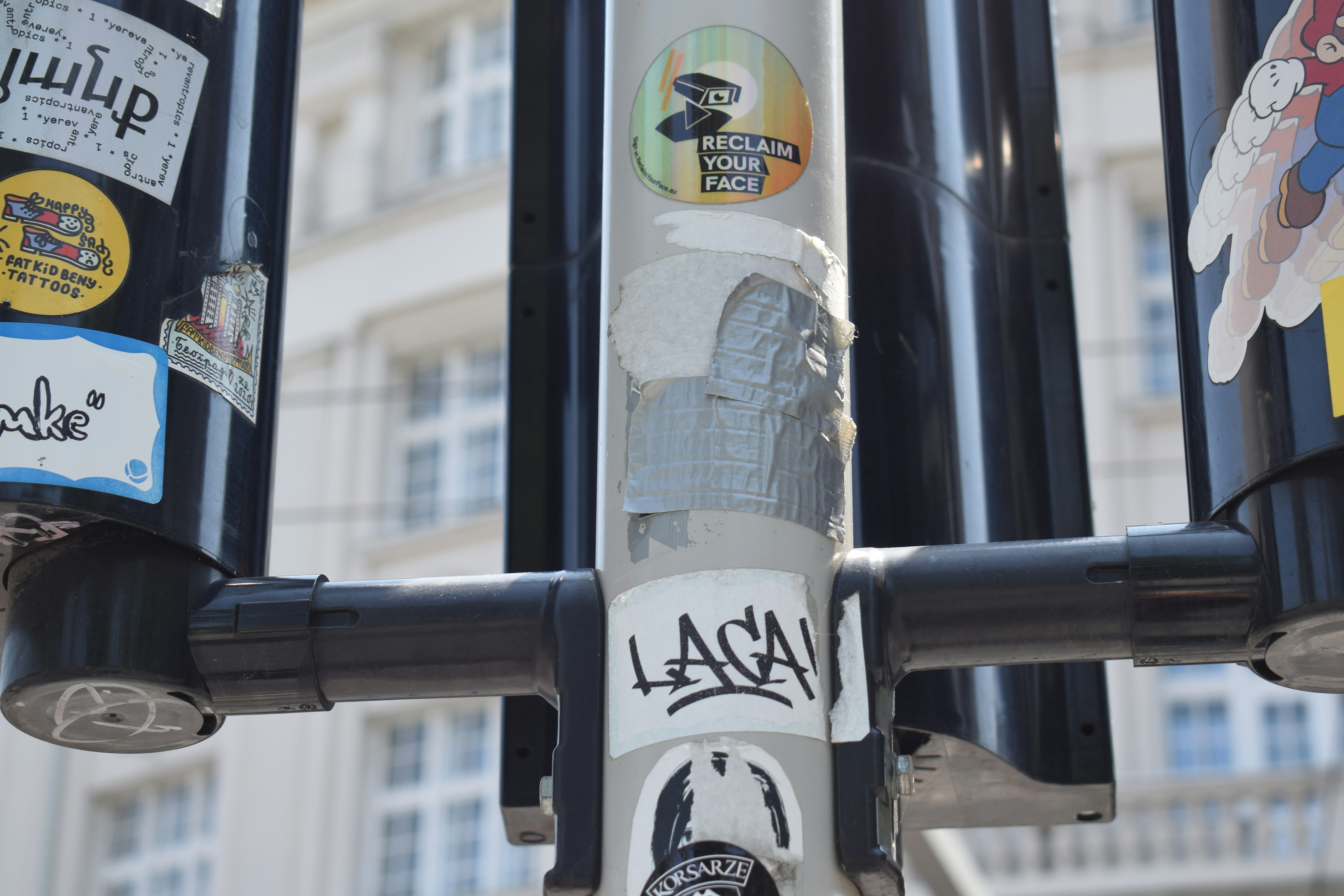 A pole with a bunch of stickers on it photo – Free City Image on Unsplash