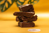 A warm, inviting shot of carrot cake and red bean brownie stacked with natural light highlighting textures.