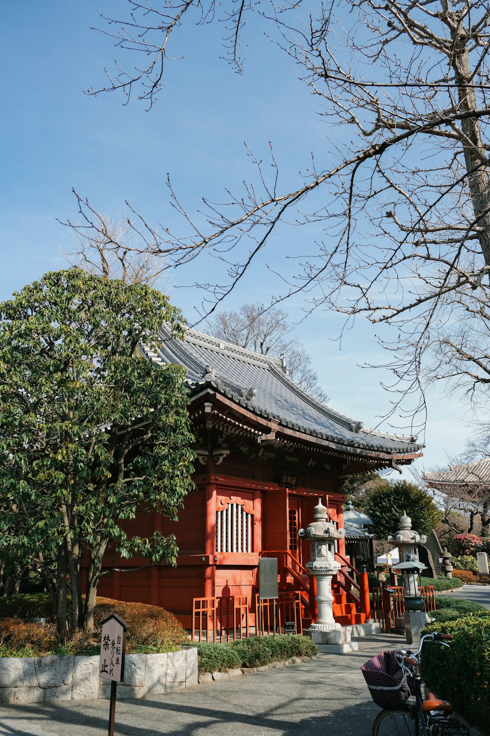 a red building with a tree in front of it