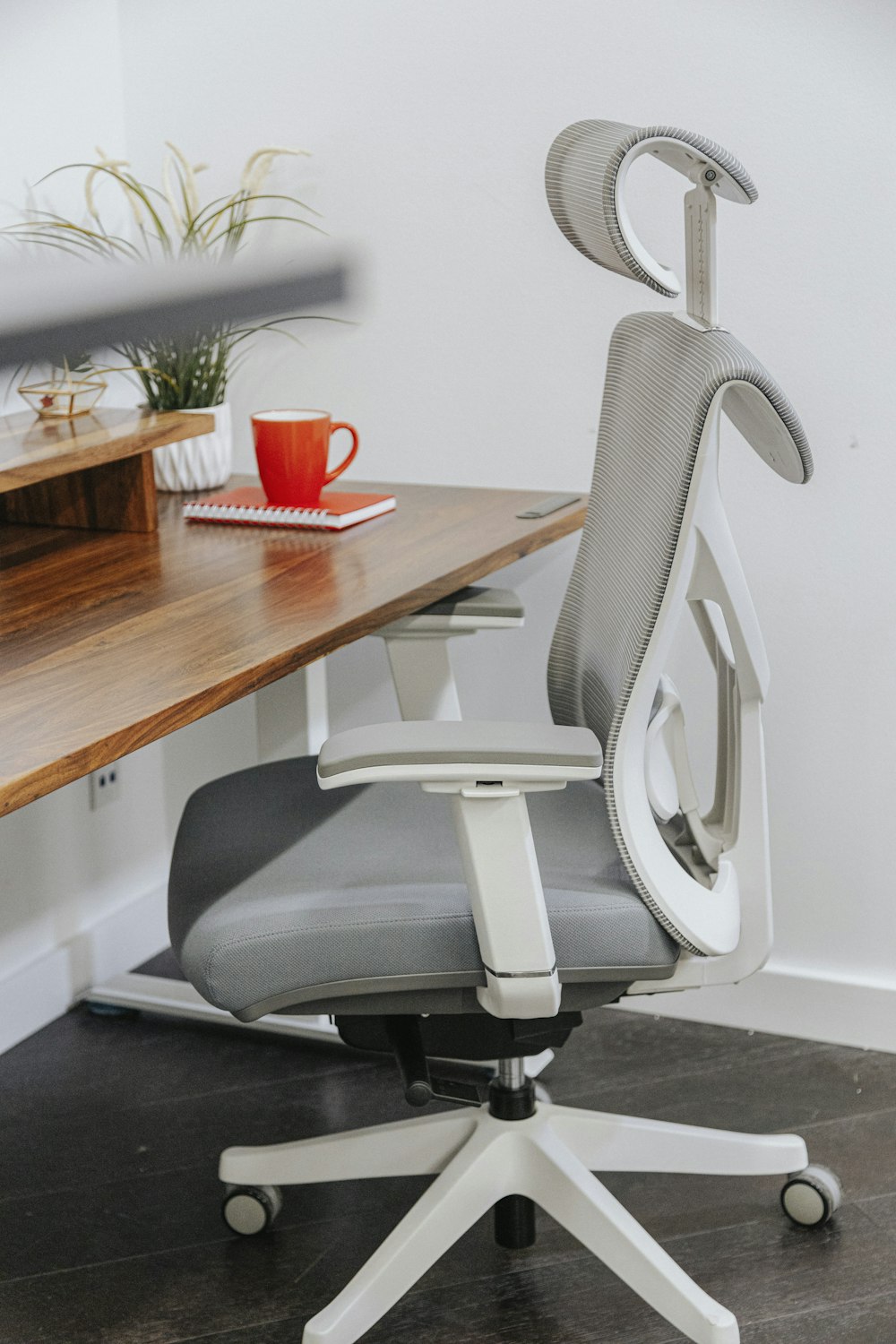 an office chair sitting on top of a wooden desk