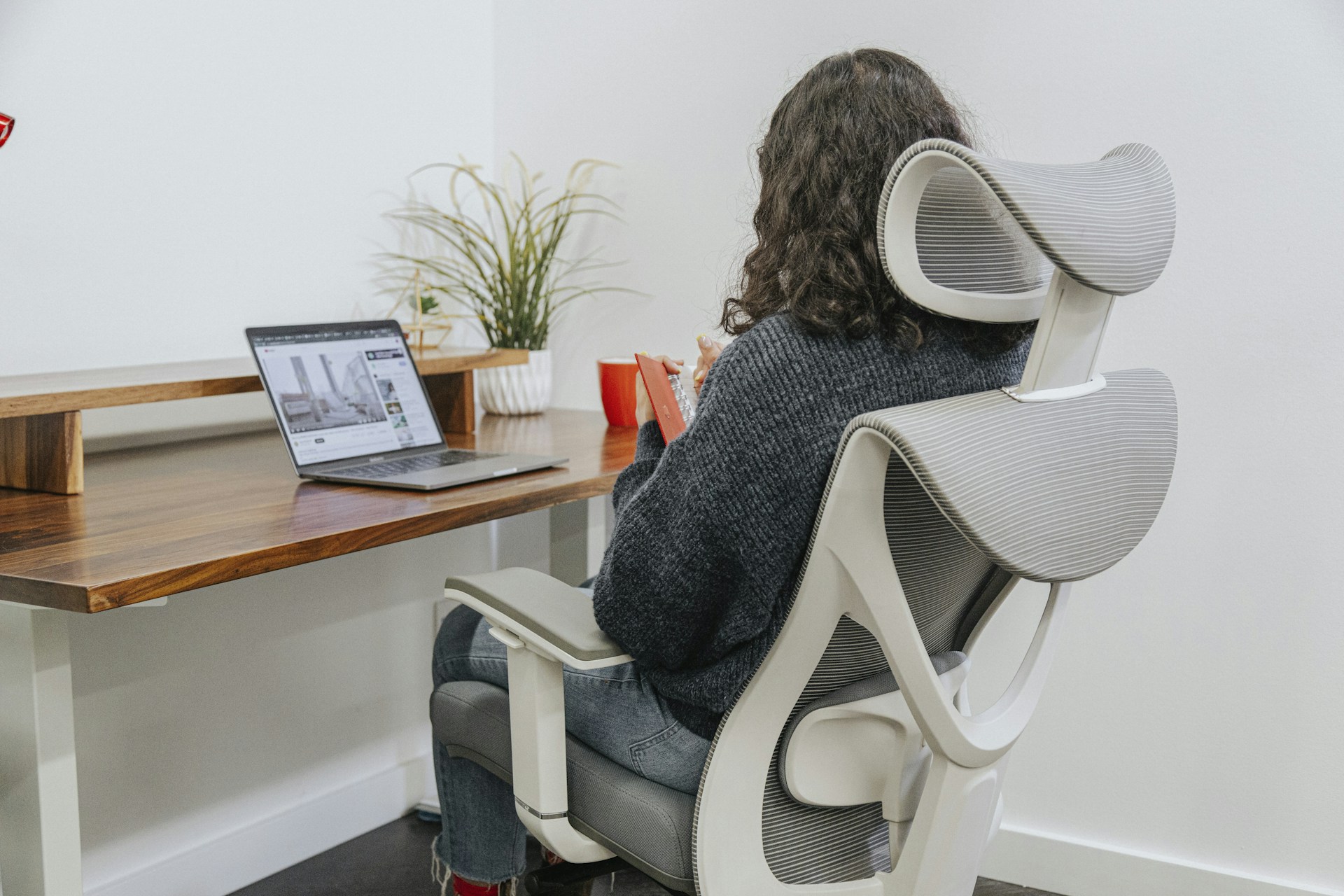 a woman sitting at a desk with a laptop