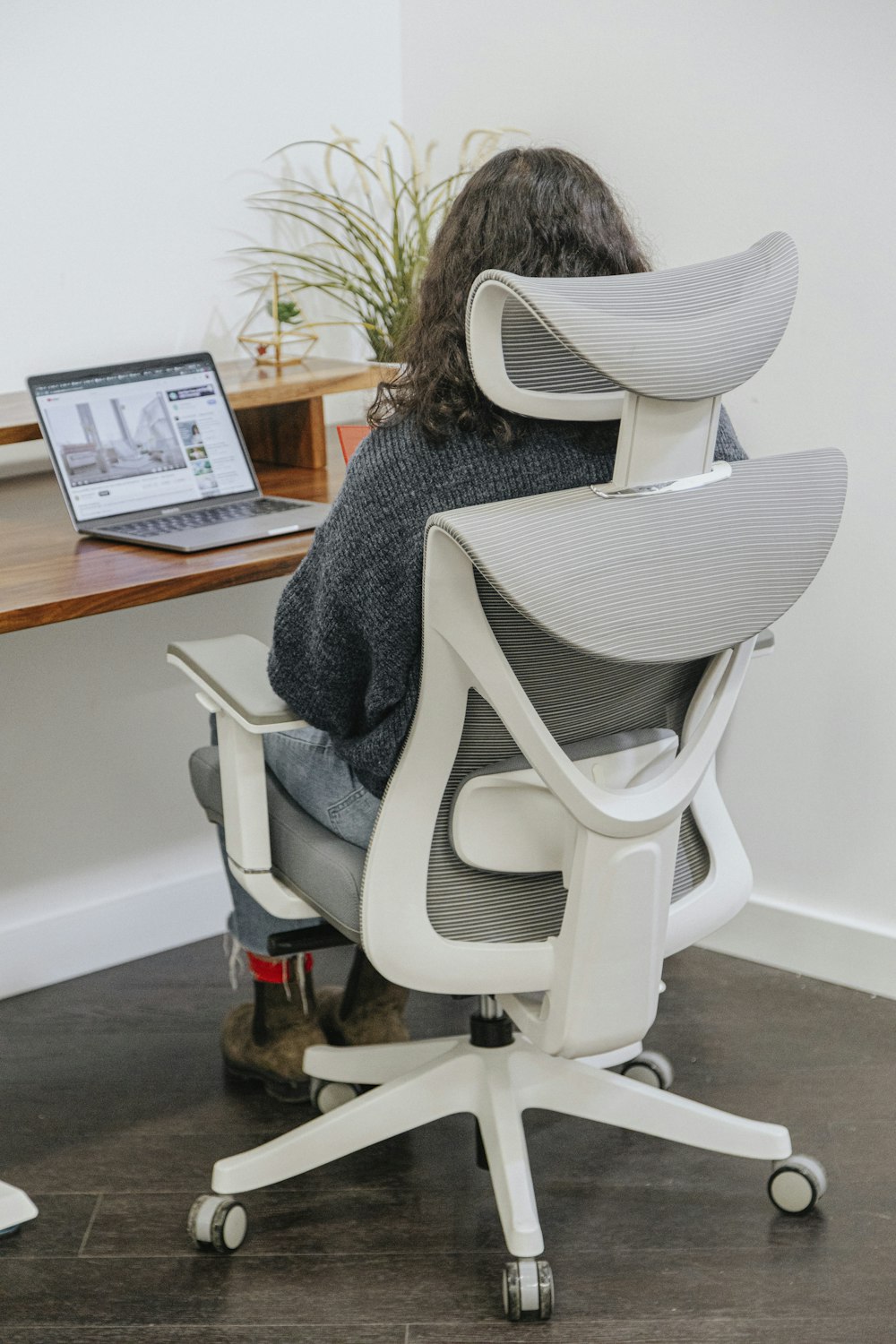 a person sitting at a desk with a laptop