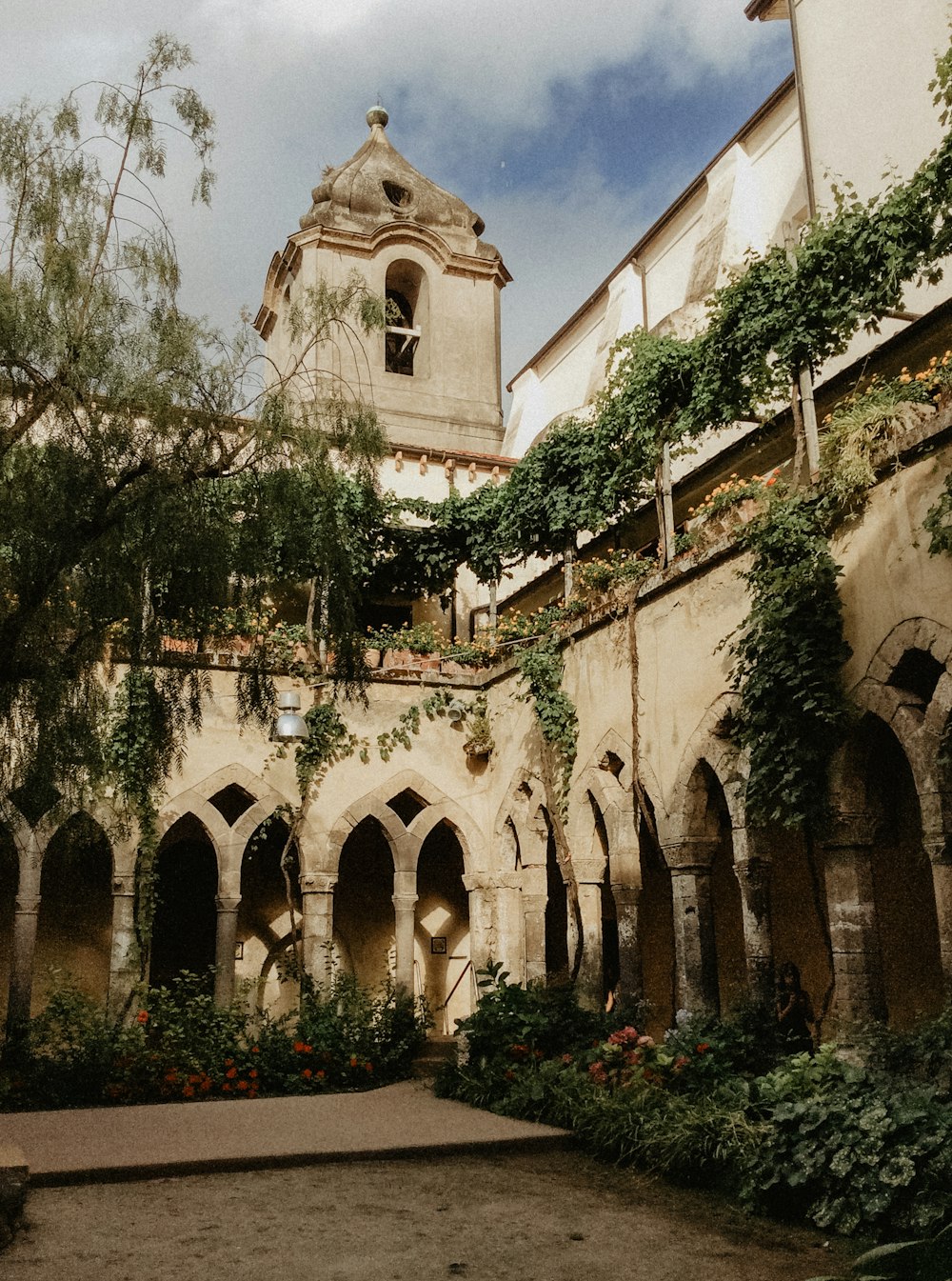 a courtyard with a clock tower in the background