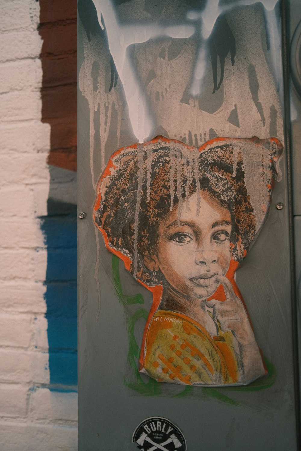 a street sign with a picture of a woman on it