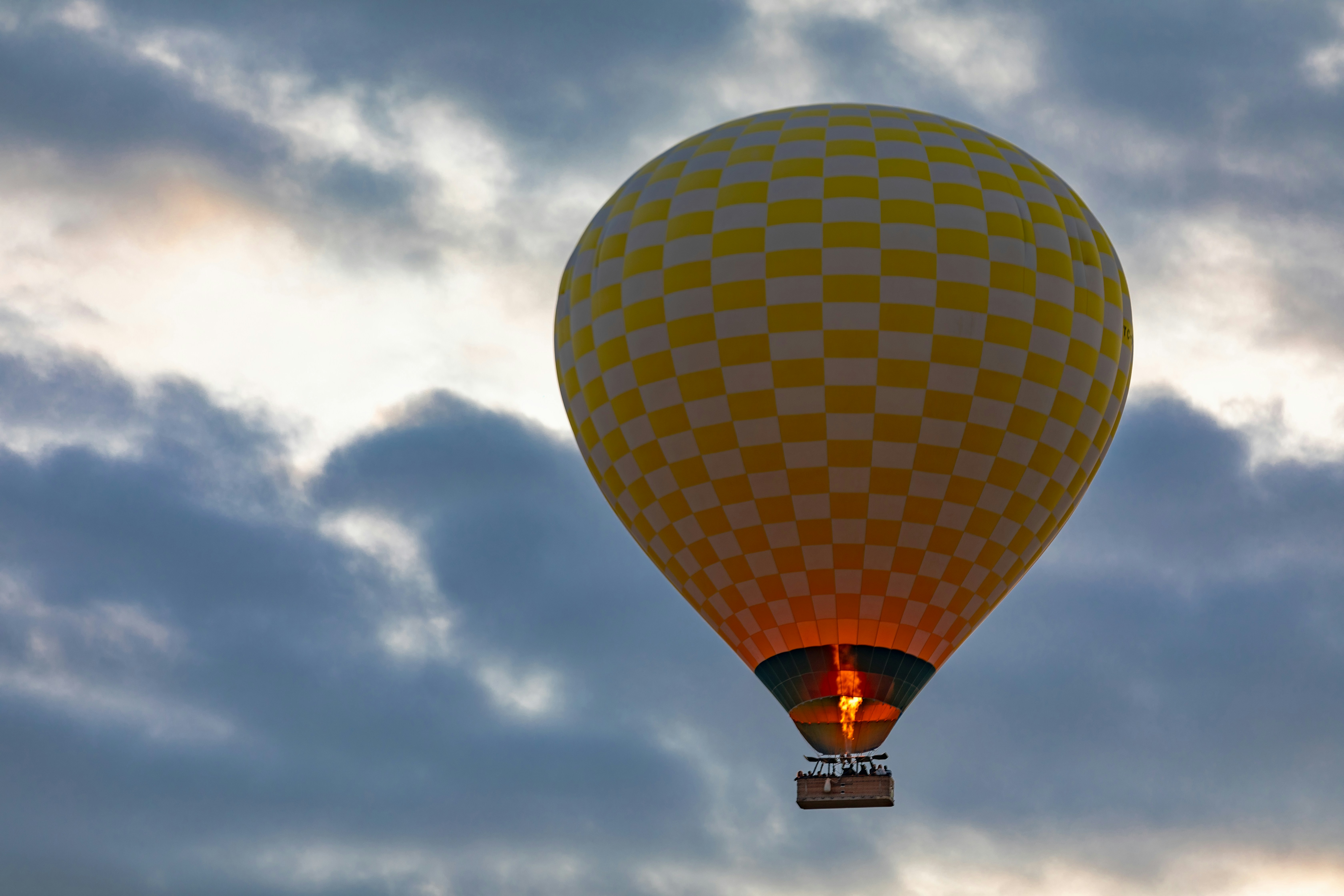 A hot air balloon flying through a cloudy sky photo – Free Cappadocia ...