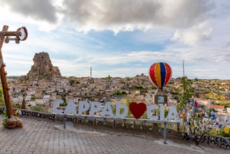 A scenic view of Cappadocia with hot air balloons in the sky.
